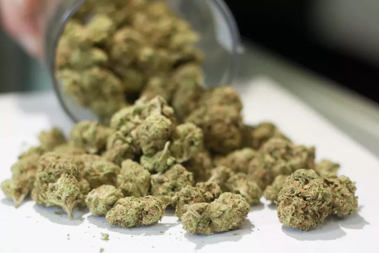 a jar of marijuana spills out on the table