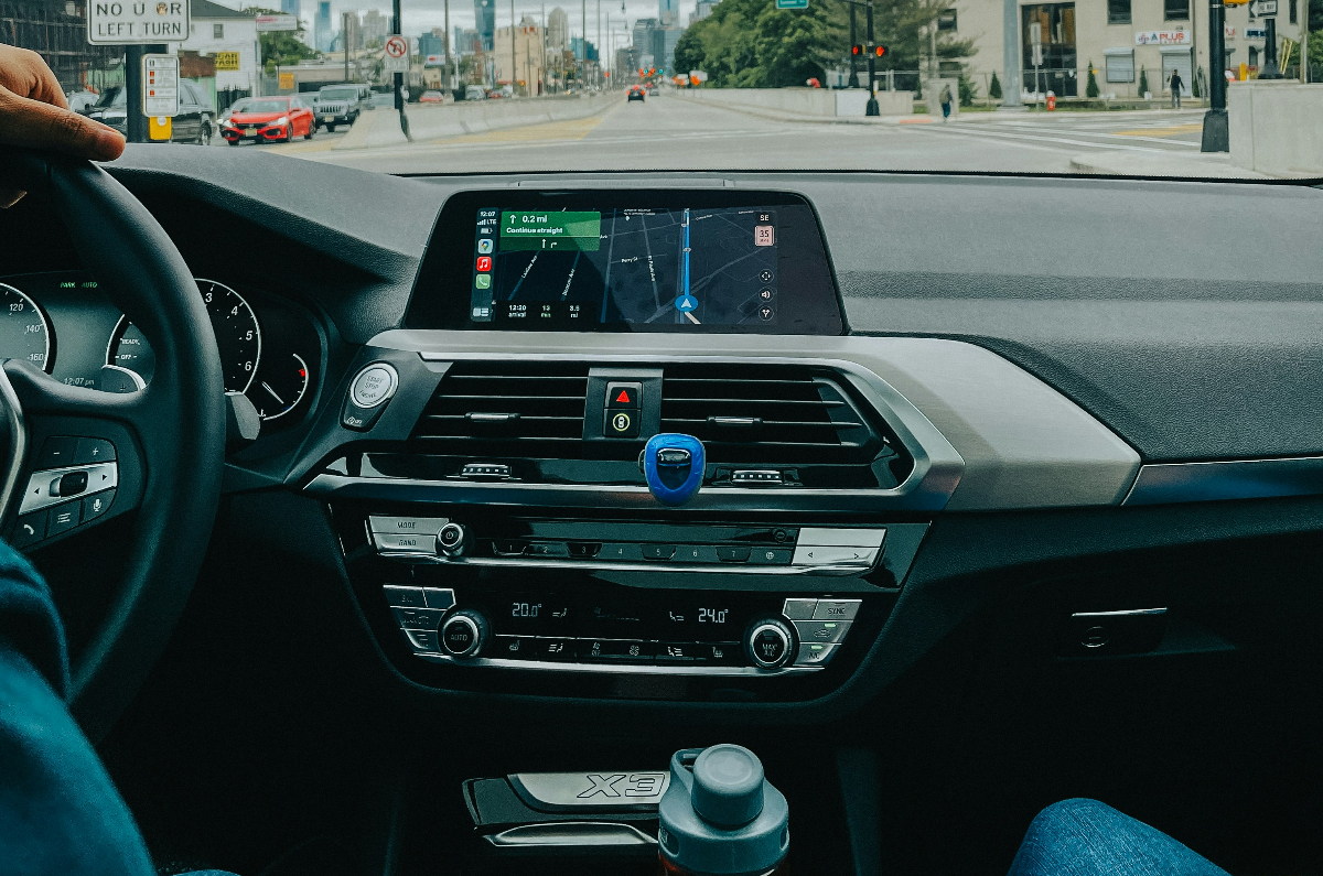 A rideshare driver drives down the street In a big city