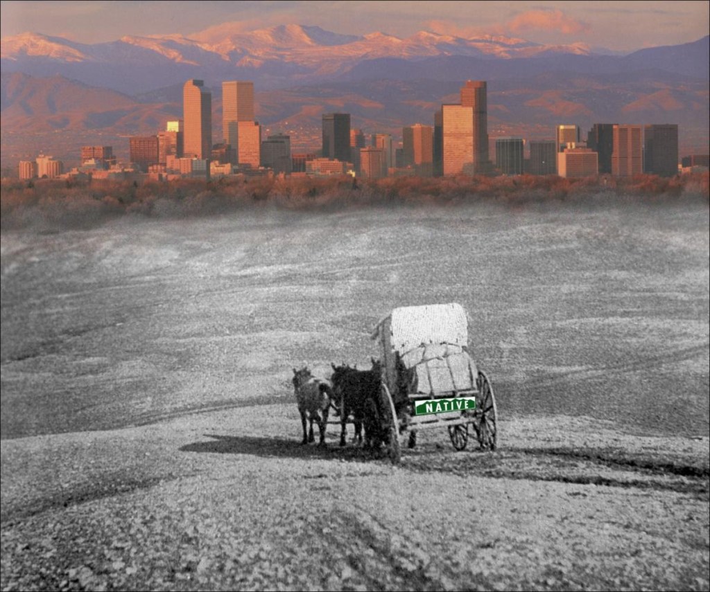 A horse and wagon going into the city of Denver