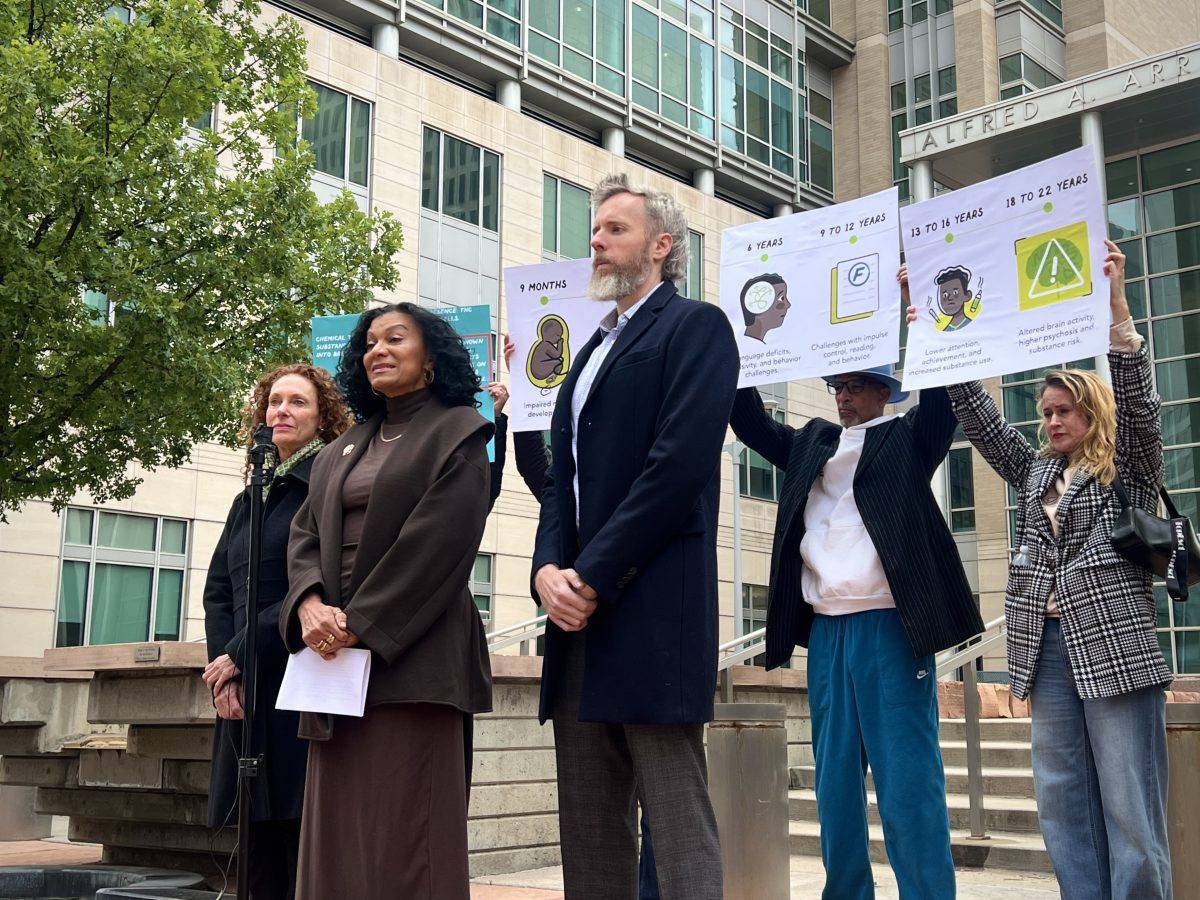 Wanda James and her attorney announce her lawsuit against the seven CU regents who voted to censure her.