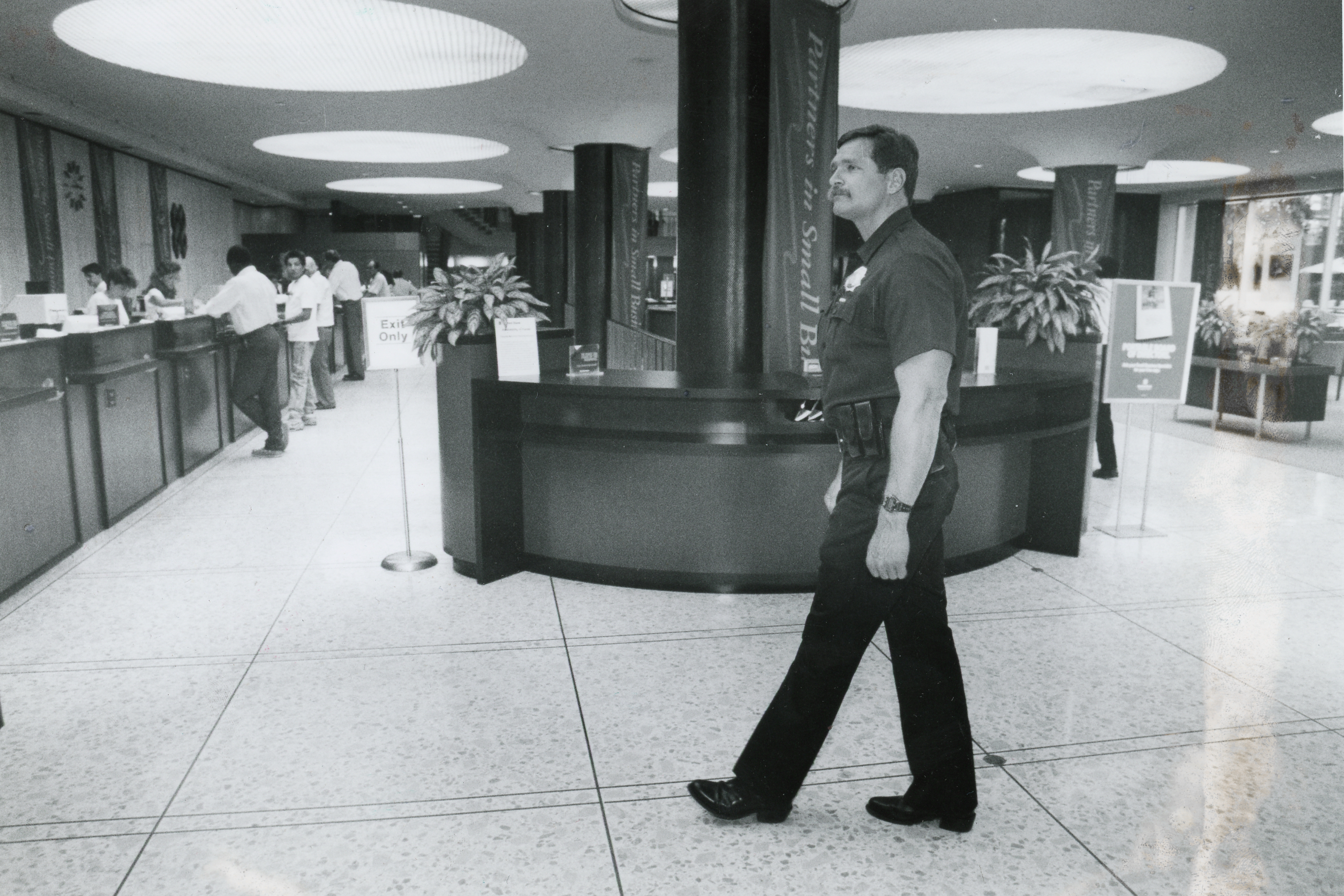 A police officer walks through United Bank in the 1980s, after the robbery and murders