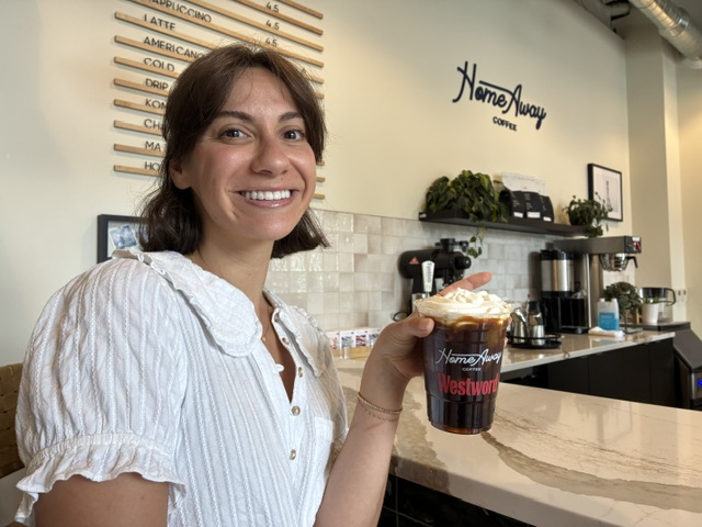 woman in white shirt with coffee drink