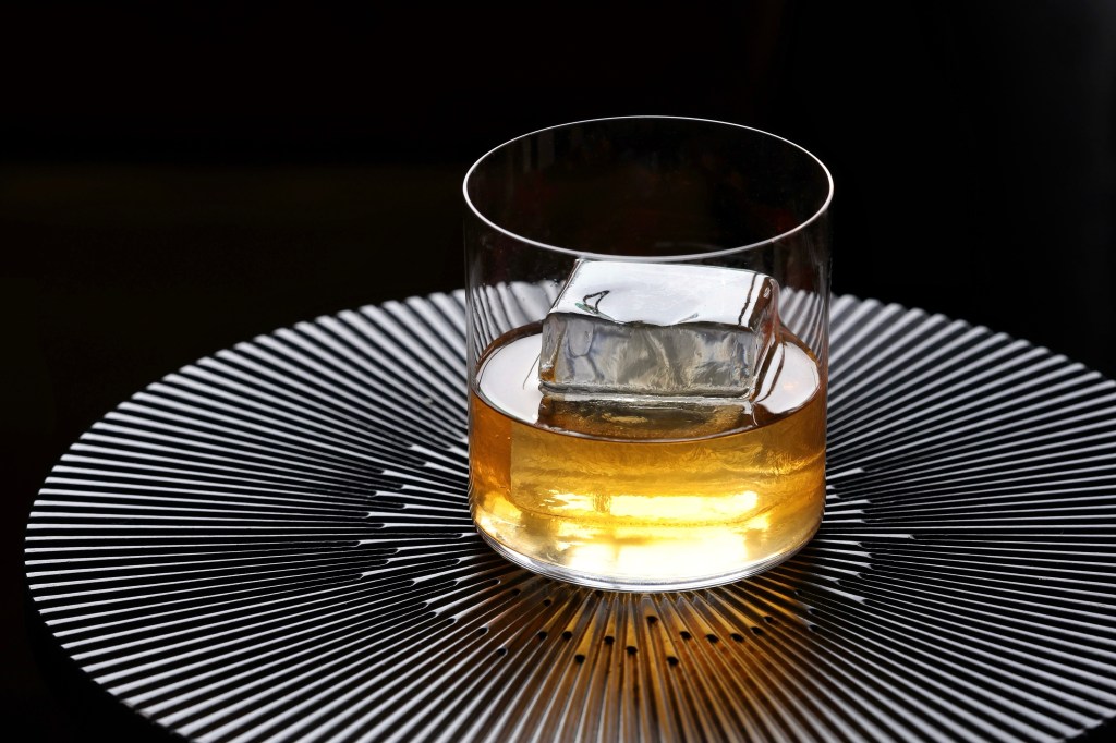 A whiskey-based cocktail from Dear Emilia, pictured with a black background