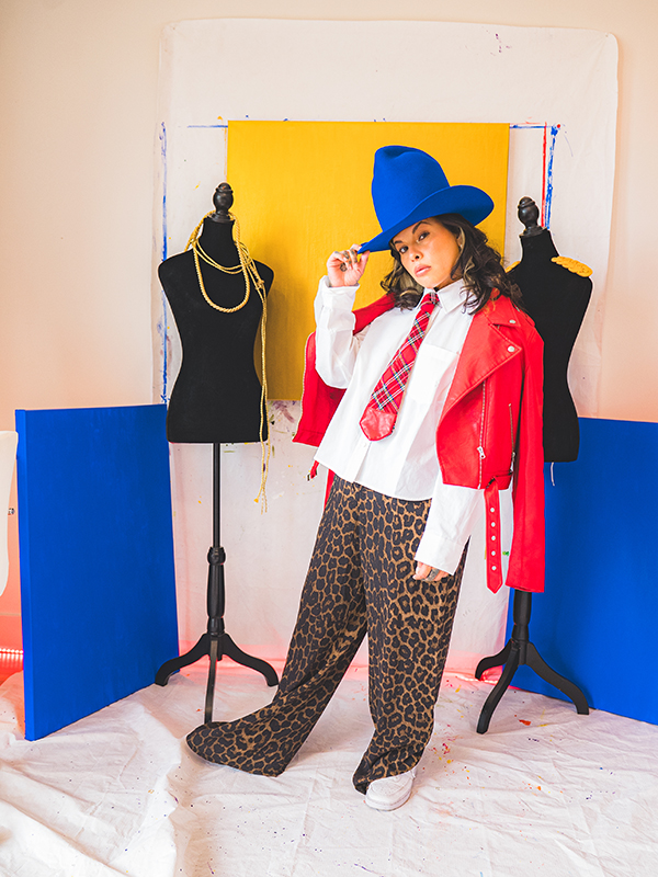 A fashion designer poses with her art