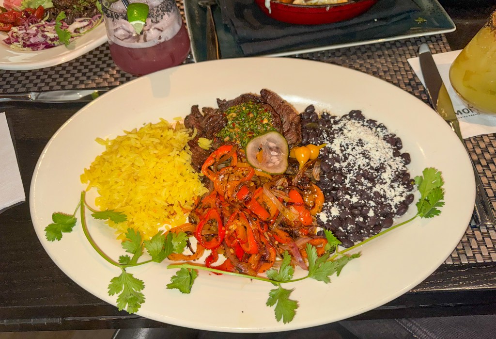 Marinated skirt steak fajitas served with vegetables, rice, and black beans at Bistro Mariposa in Black Hawk.