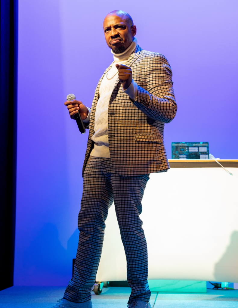 Old Man Saxon on stage in beige suit