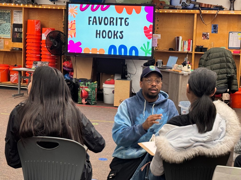 Old Man Saxon talking to students