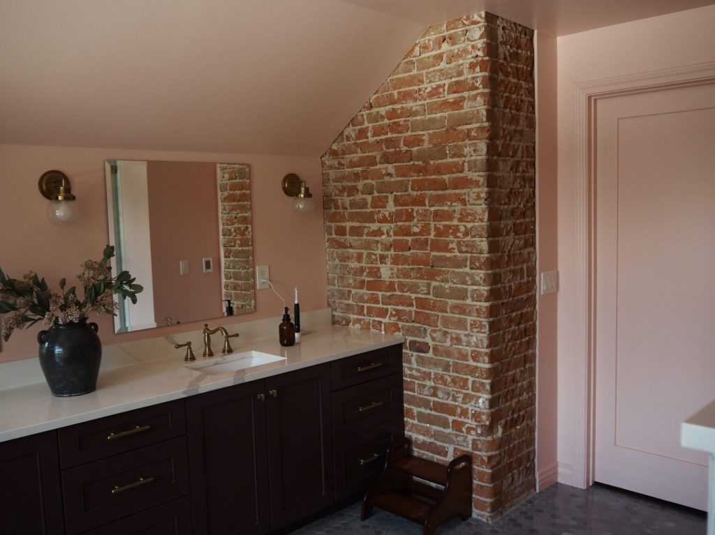 Exposed brick in the largest bathroom.