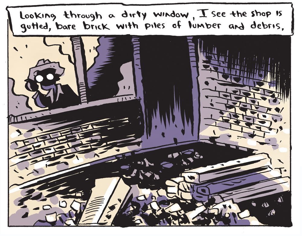 He peers through the window, noting the store's gutted interior.