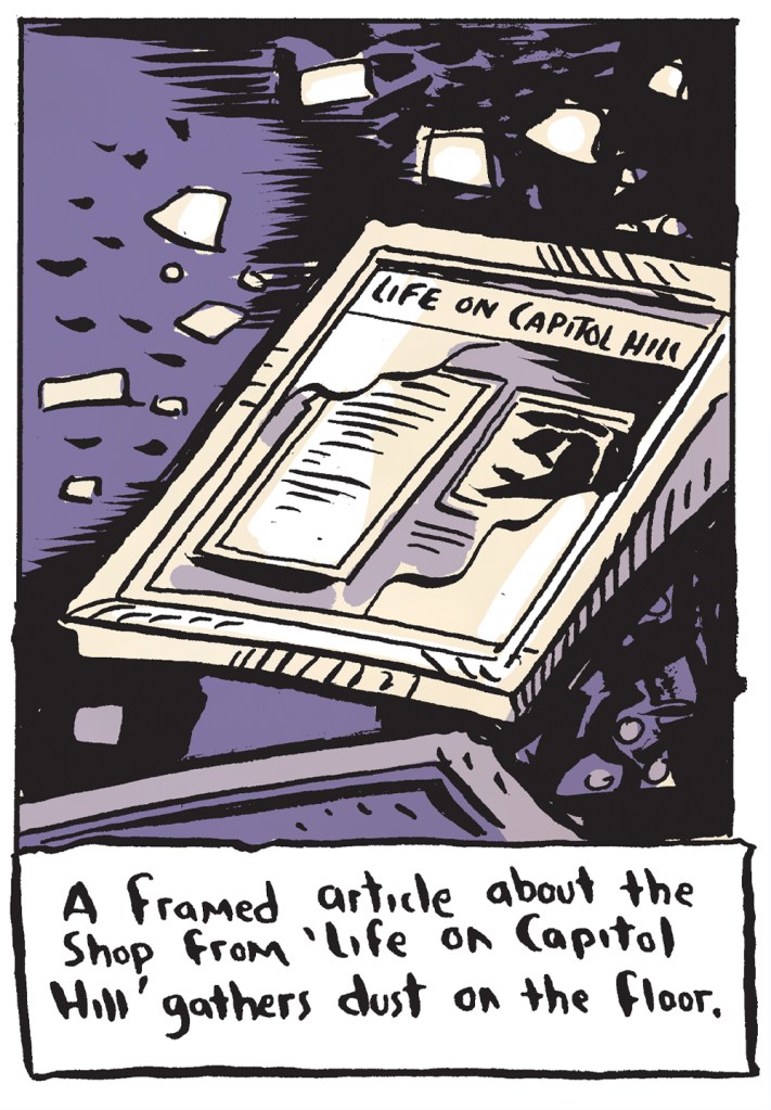A framed article about the shop gathers dust on the floor.
