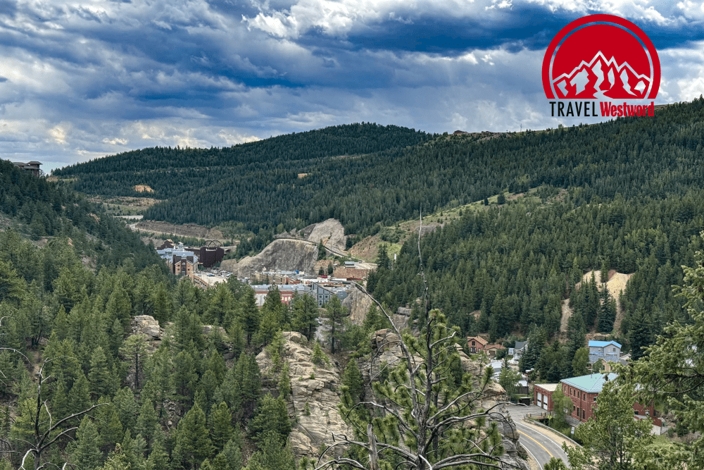 An aerial view of Black Hawk. The city and casinos sit nestled in between trees and mountains.