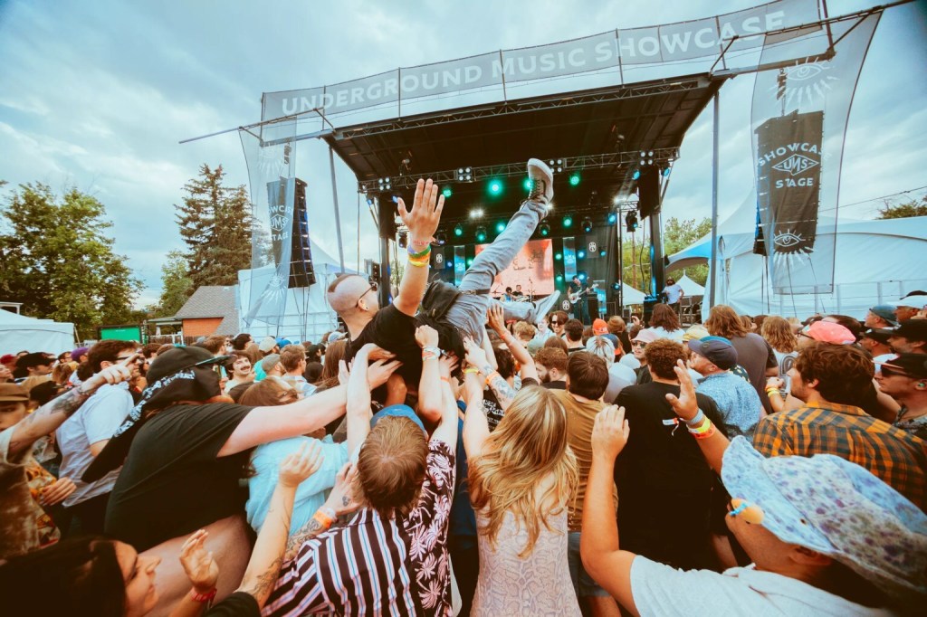 A person crowd surfing during an Underground Music Showcase concert