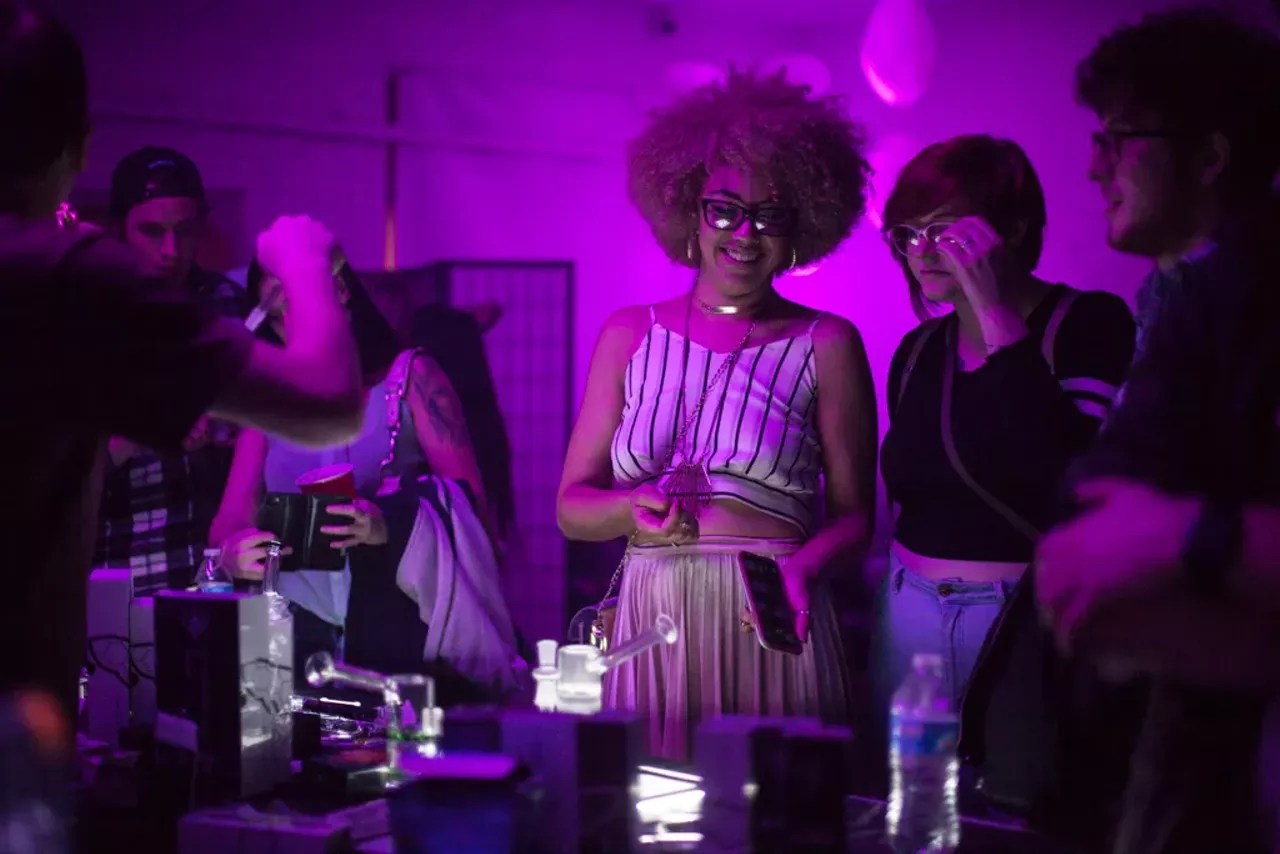 Two women check out a glass vendor at Tetra Lounge