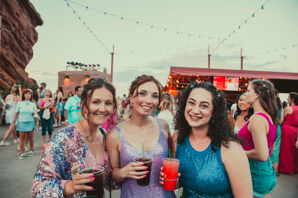 Concertgoers pose for a picture at the top of Red Rocks.