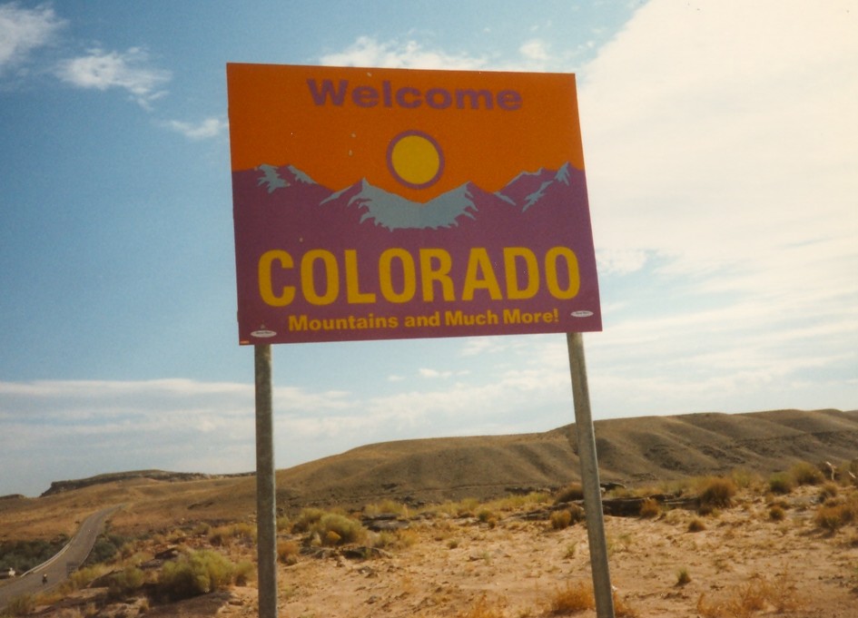 Purple and Orange "Welcome to Colorado" signs from the 1990s