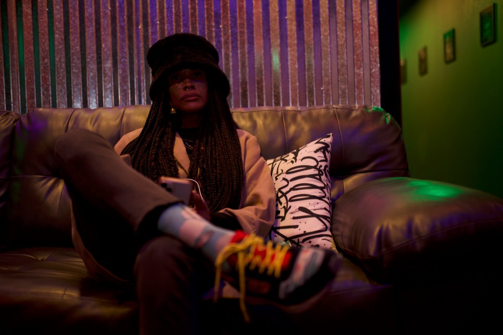 woman in hat on leather couch