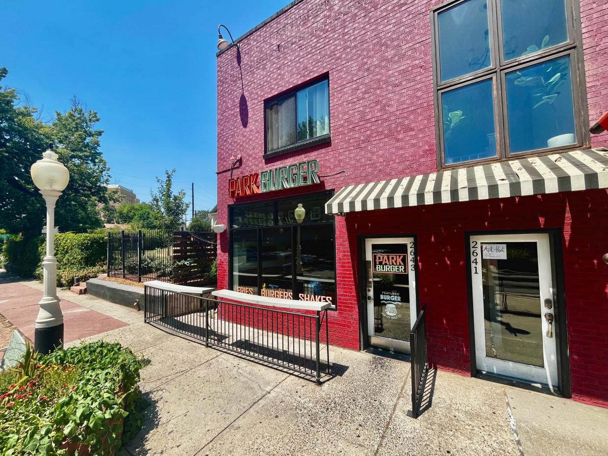 The front of the red brick Park Burger location in the Highland neighborhood on a sunny day.