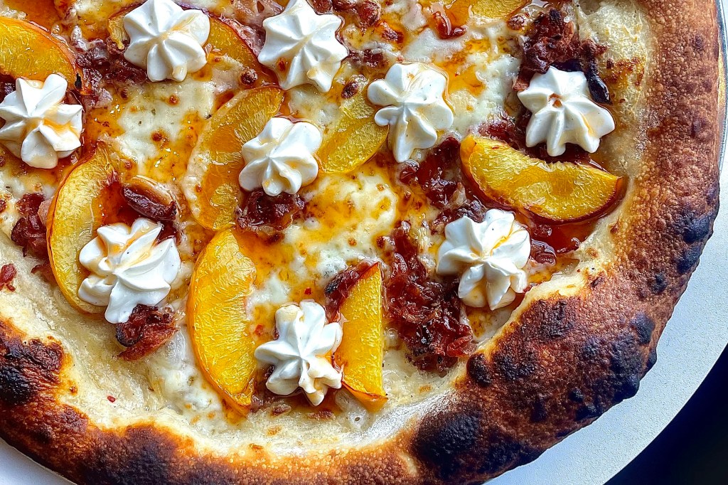 Peaches and dollops of ricotta on a pizza