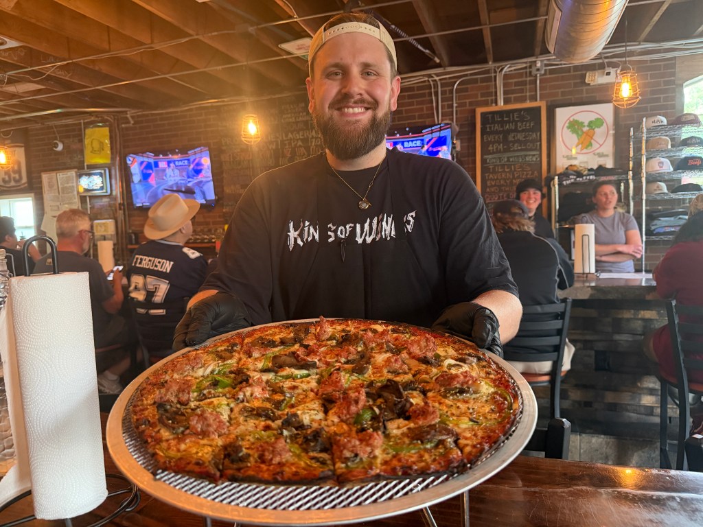 King of Wings' kitchen manager Mitch Conley serves up a Tillie's pizza on its popup night