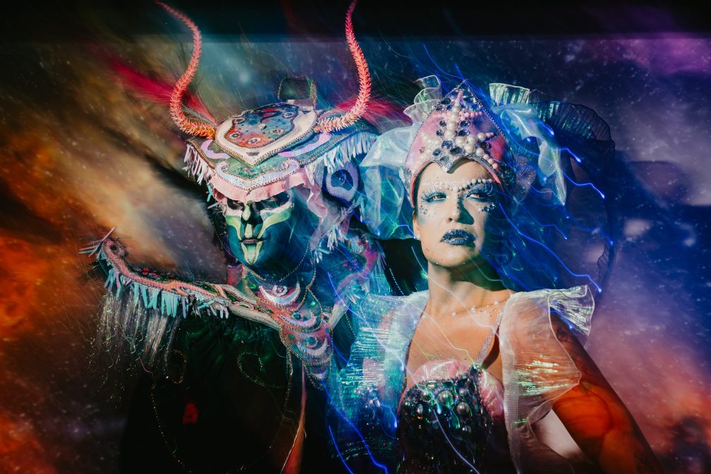 Two people pose in a sci-fi setting