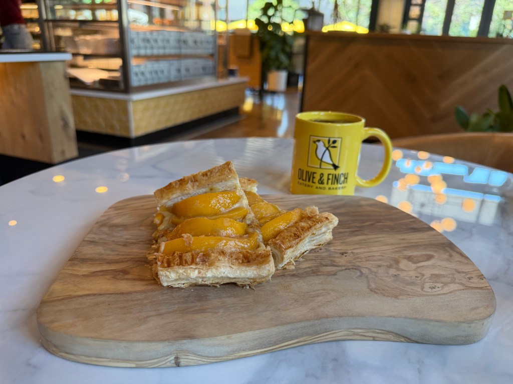 Peach mille-feuille next to a mug of coffee