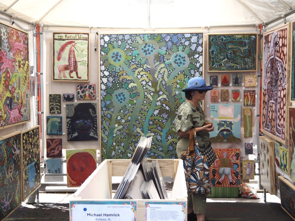 People look at art at the Cherry Creek Arts Festival