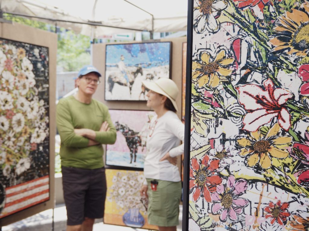 People look at art at the Cherry Creek Arts Festival