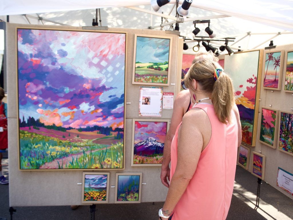 People look at art at the Cherry Creek Arts Festival