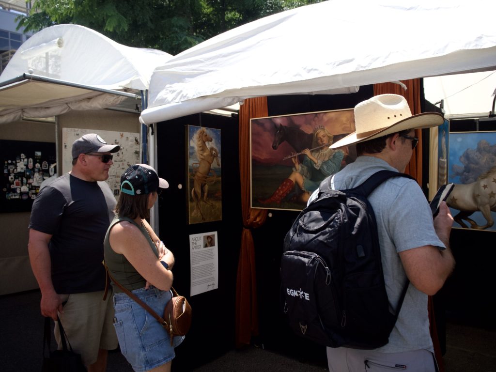 People look at art at the Cherry Creek Arts Festival