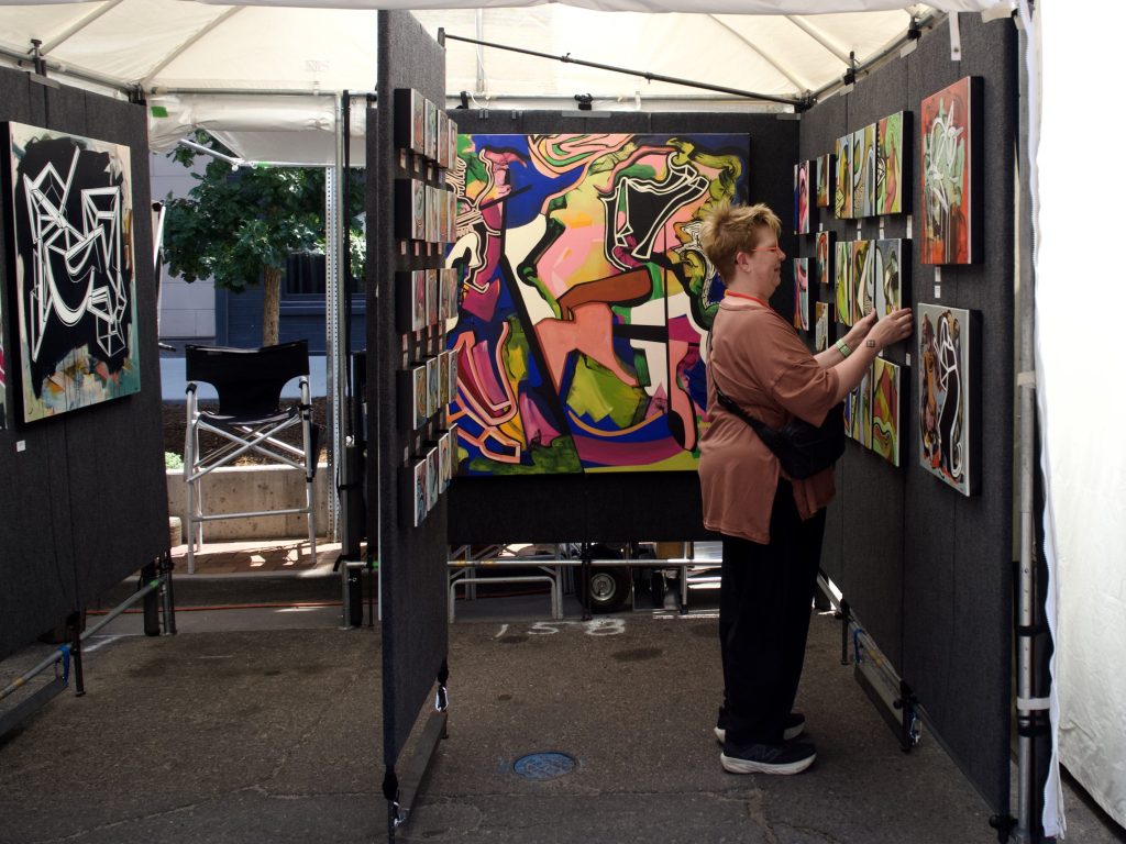 People look at art at the Cherry Creek Arts Festival