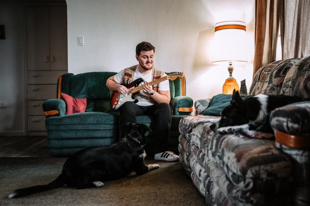 man with guitar and 2 dogs