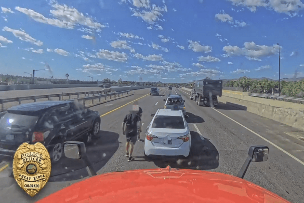 Two drivers get out of their vehicles to fight on Interstate 70 during a road rage incident on June 10, 2026.