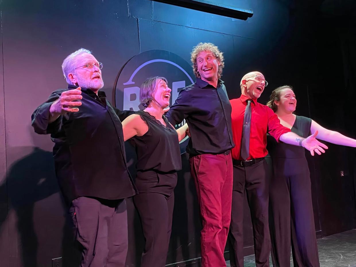 Performers sing onstage