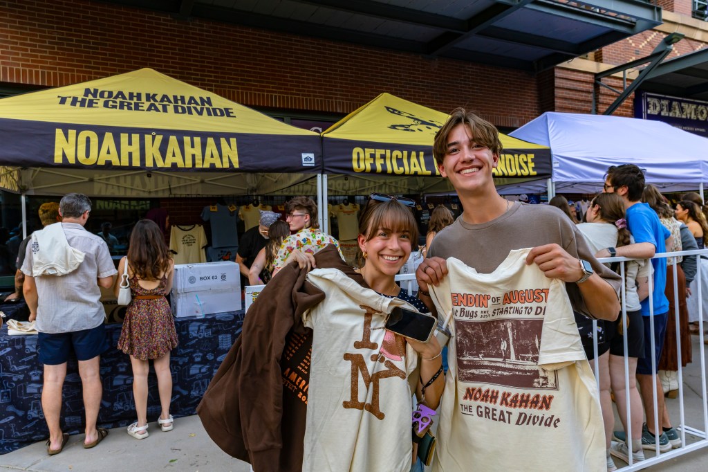 A photo showing fans outside of Coors Field with their artist merch.