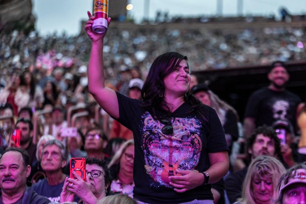Concertgoers dancing to Santana perform live at Red Rocks on August 24.