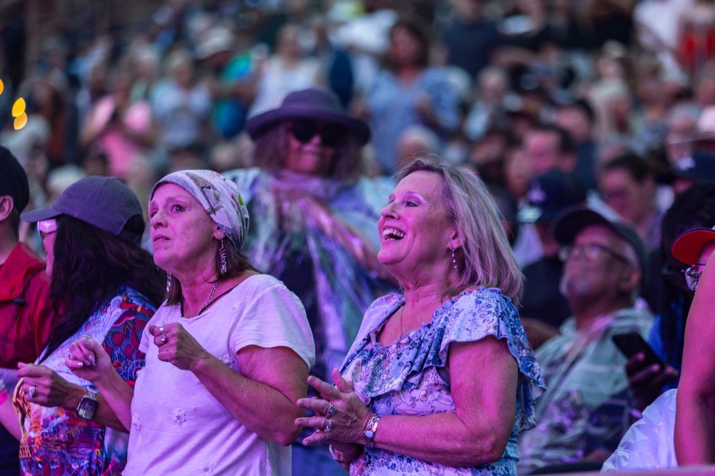 Concertgoers dancing to Santana perform live at Red Rocks on August 24.