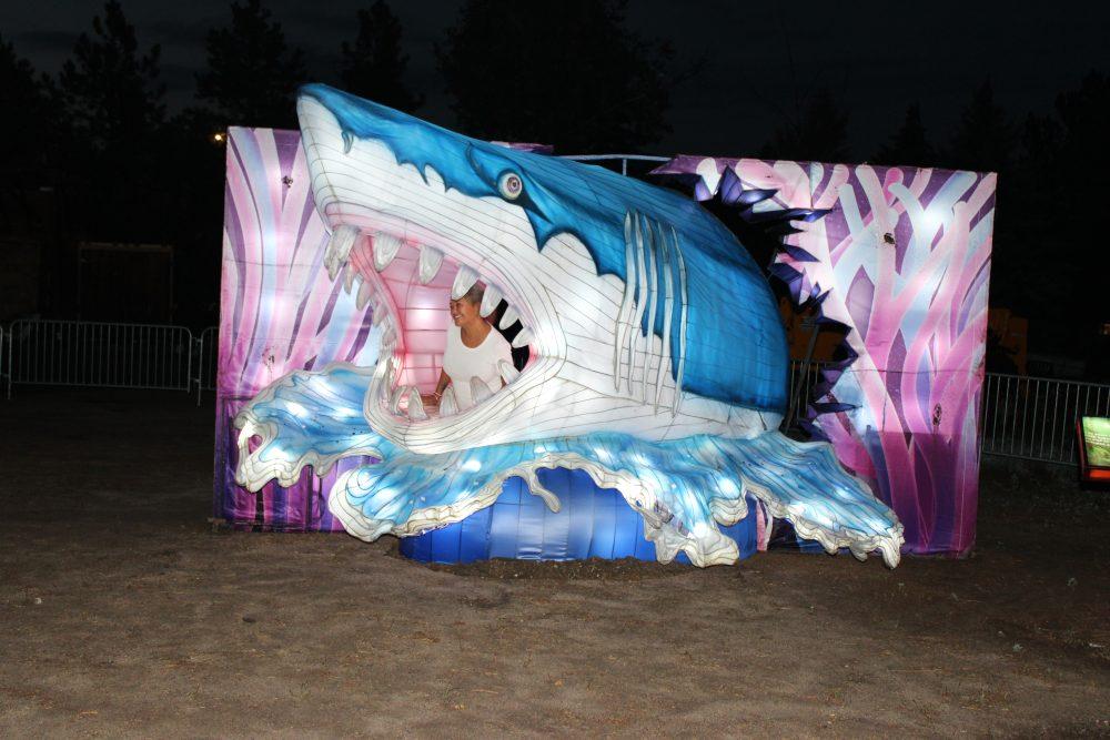 A woman poses inside a shark lantern
