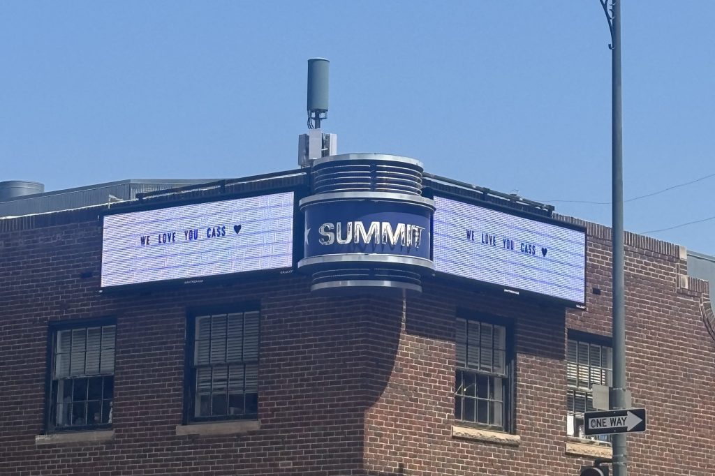 The marquee outside Summit Music Hall reads "We love you Cass."