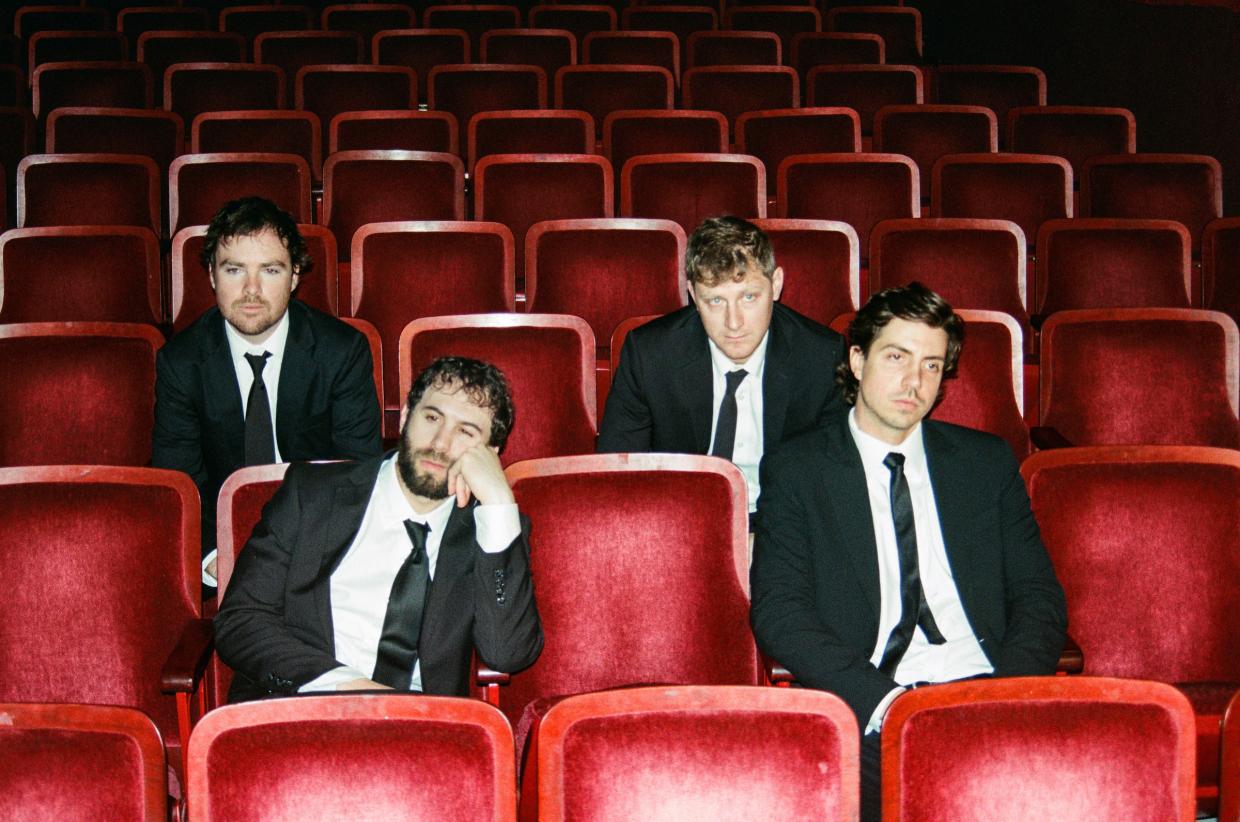 Walden band members sit in an auditorium