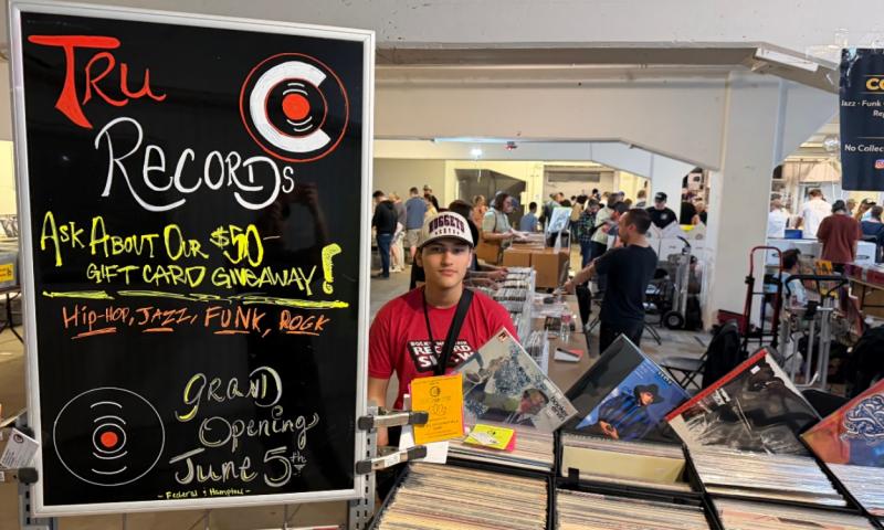 Elijah Trujillo, TruRecords' owner, sits at a vendor table to promote the store.