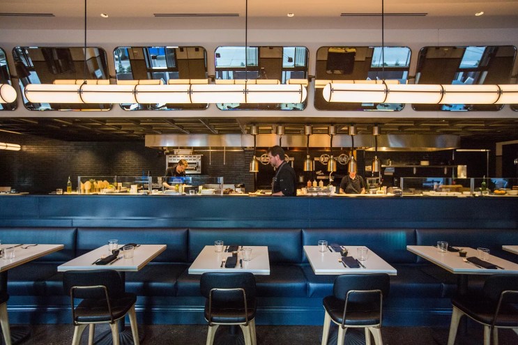 tables in front of a restaurant kitchen