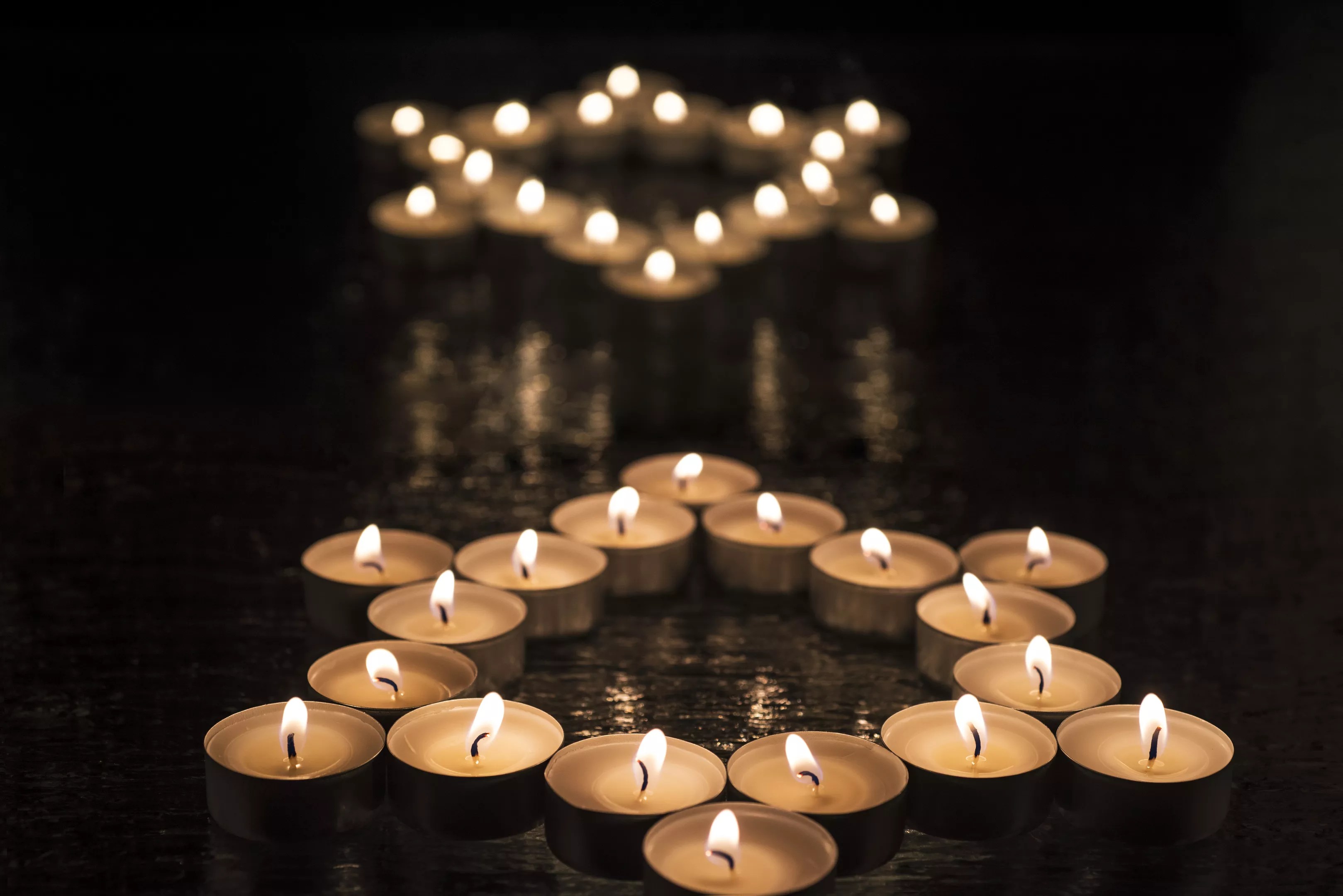 Collections fo tea candles form two stars of David.