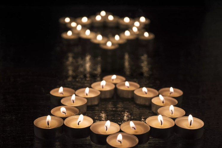 Collections fo tea candles form two stars of David.