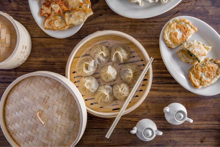 a steam basket with dumplings