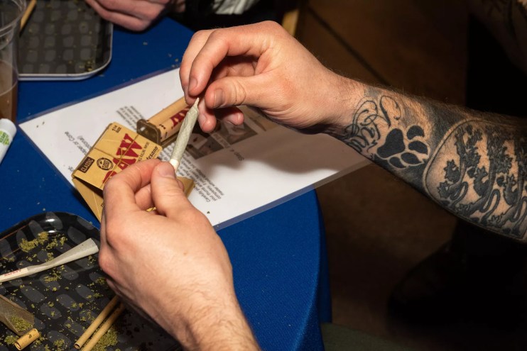 A man rolls a joint of cannabis