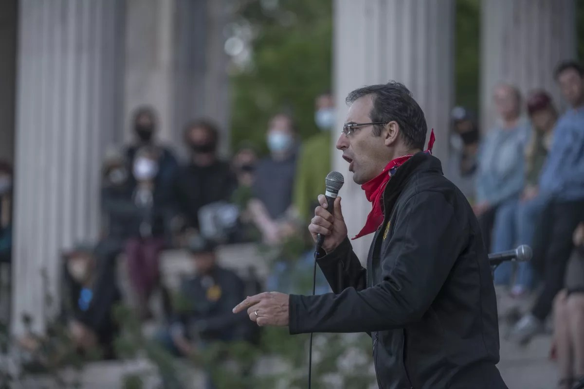 Man speaks to crowd