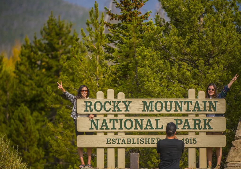 tourists posint outside rocky mountain national park