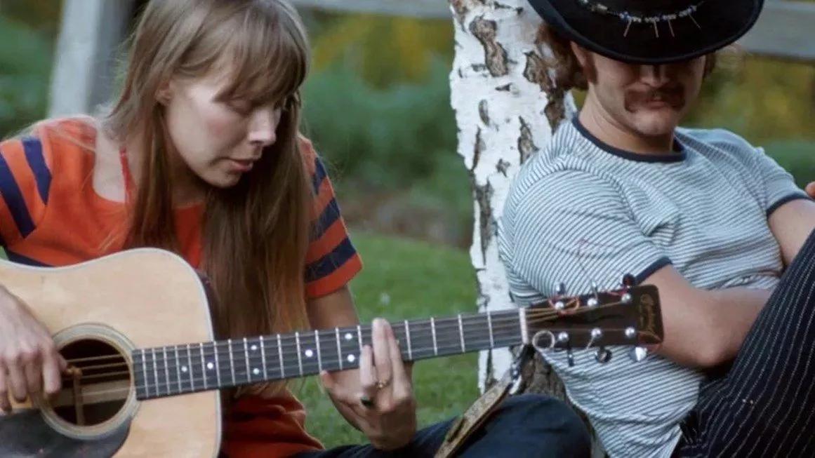 Joni Mitchell playing guitar