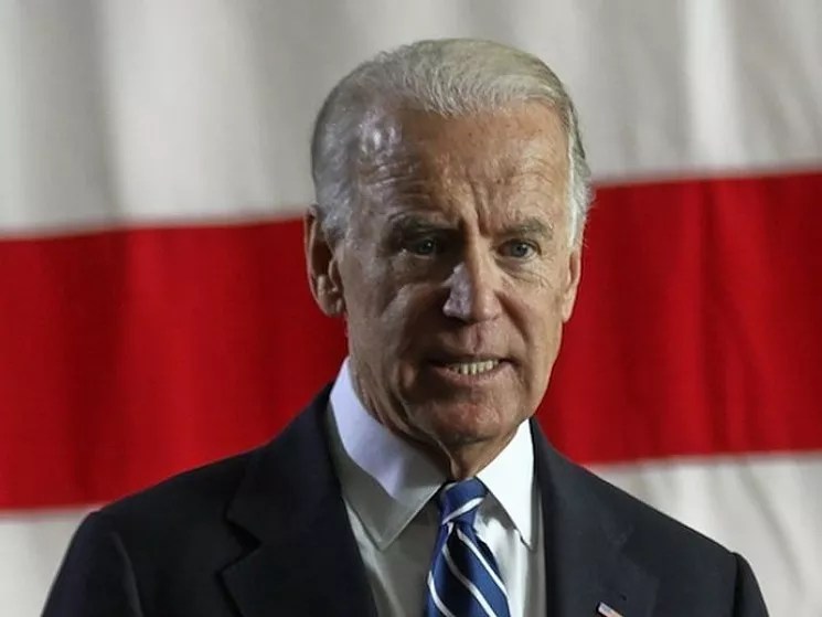 Joe Biden in front of flags