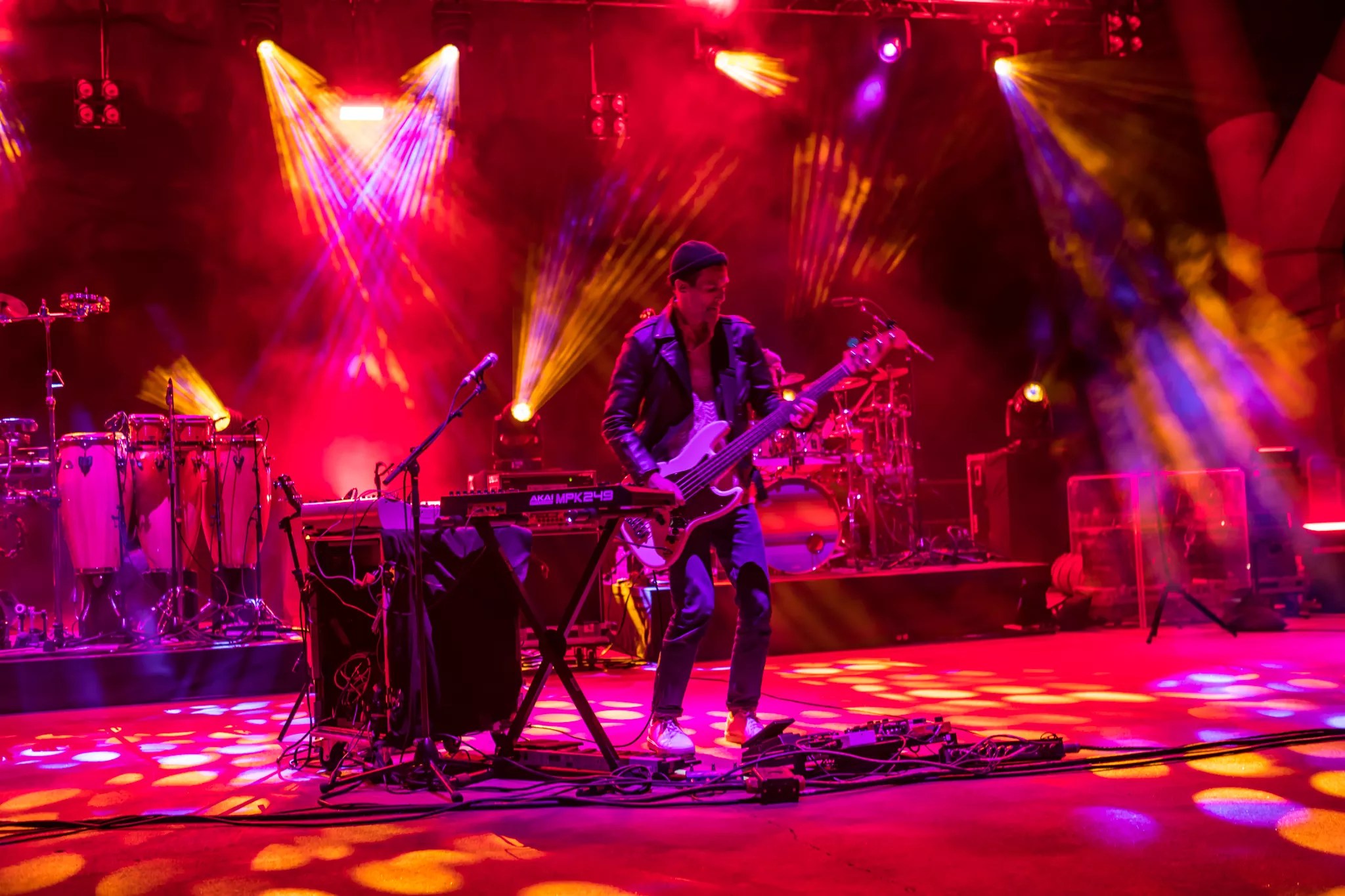 band plays against red backdrop